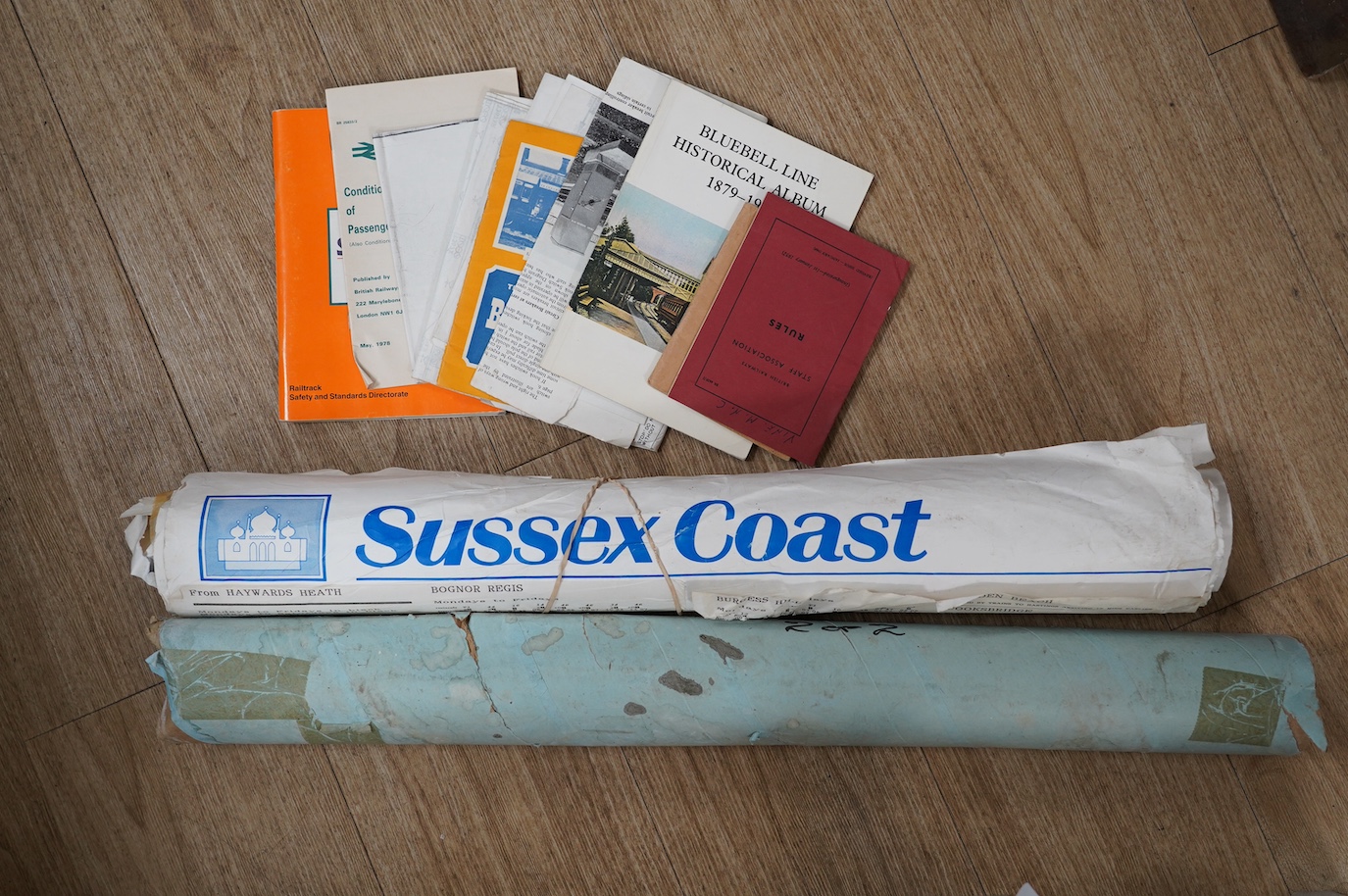 An archive of 1950s-90s railway memorabilia including; internal British railways publications, Bluebell Railway related items, a large quantity of Sussex related poster timetables, a BR rule book, NUR badges, a Gatwick E